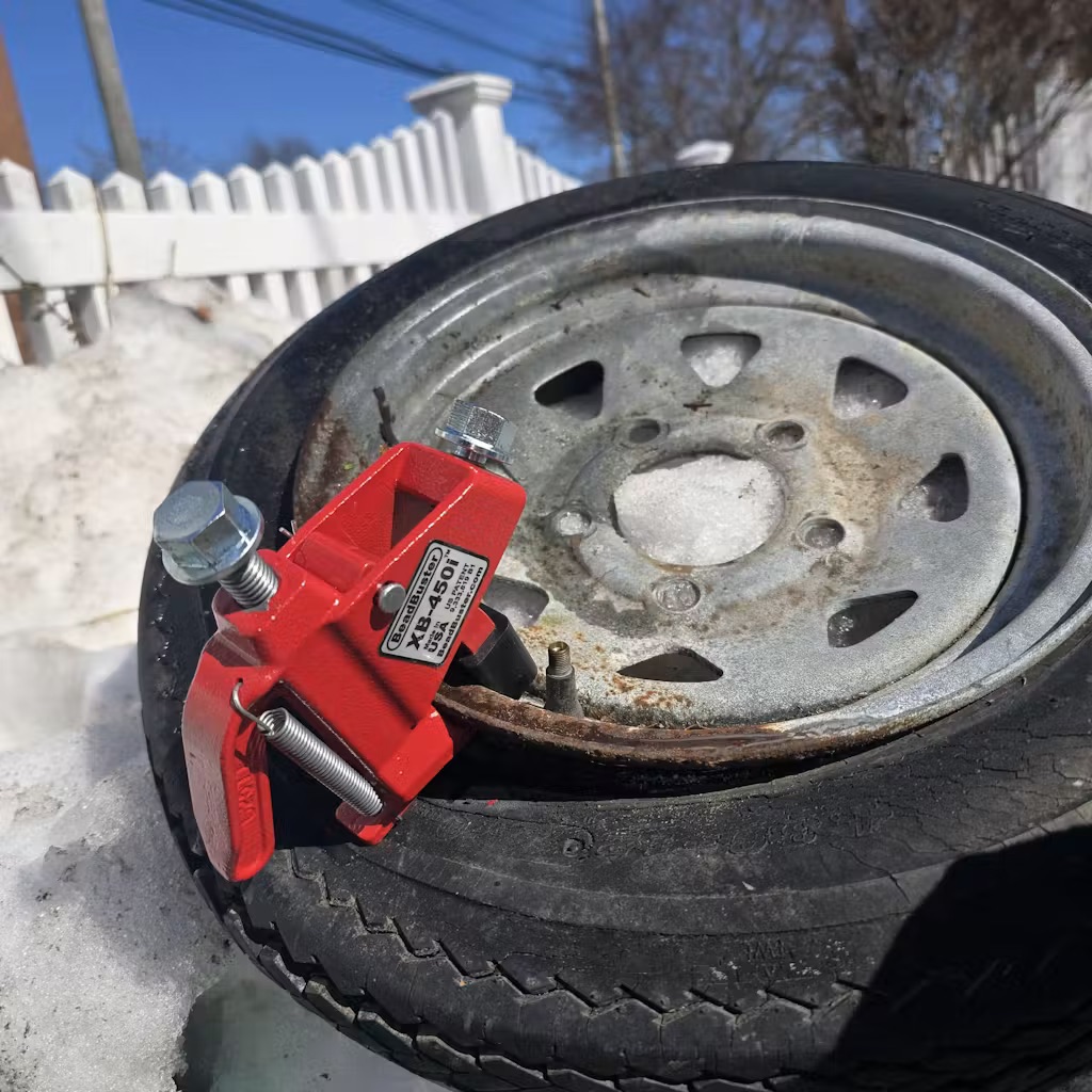 Jerry S. breaking the bead on a rusty trailer wheel with the BeadBuster XB-450i